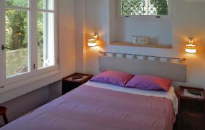 a bedroom with a bed with pink and purple pillows at Villetta in Verde! Magnificent sea view in Akrotiri