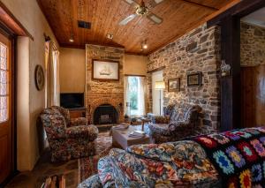 a living room with a couch and a stone wall at Lemke Cottage Barossa Valley in Moculta