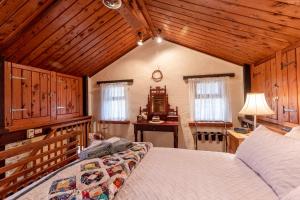 a bedroom with a large bed in a room with wooden ceilings at Lemke Cottage Barossa Valley in Moculta