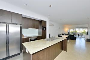 a kitchen with a stainless steel refrigerator and a counter at DelMar 3 in Mandurah