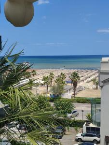 a view of a beach from a building at Hotel Ambassador in Rimini