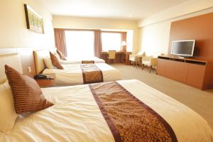 Llit o llits en una habitació de Fujisan Garden Hotel
