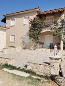 a house with a stone patio in front of it at Studio Romantica in Laganas