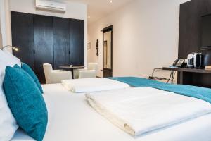 Postel nebo postele na pokoji v ubytování RheinCity Hotel & Boardinghouse