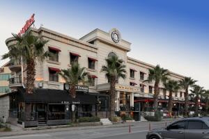 a building with a clock on top of it on a street at New Balturk Hotel Izmit in Kocaeli