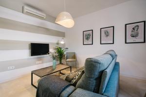 Televízia a/alebo spoločenská miestnosť v ubytovaní Encarnación Suite Apartment