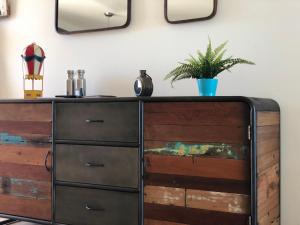 a dresser with a plant on top of it at Apartamento Adrover in Cala Millor