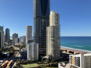 a view of a city with tall buildings and the ocean at High Floor Ocean View at Surfers Paradise - Hotel Studio in Gold Coast