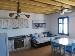 a living room with a couch and a table at Tirquaz View in Serifos Chora