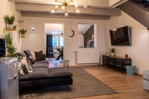 a living room with a couch and a table at MODERN WESTERN - Apartment BLUE in Eging am See