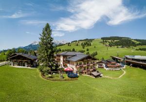 an aerial view of a resort with a tree at Hotel Langeck in Maria Alm am Steinernen Meer