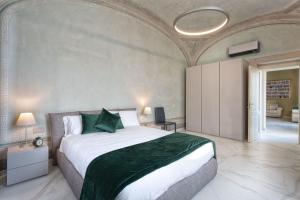 a bedroom with a large bed with a green blanket at Casa del Sarto in Florence