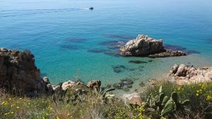 a view of a body of water with rocks at Bonavista Studio with a Balcony - Calella in Calella