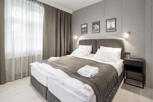Postel nebo postele na pokoji v ubytování Apartamenty L11, Limanowskiego