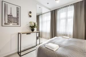 Postel nebo postele na pokoji v ubytování Apartamenty L11, Limanowskiego