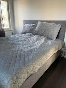 1 cama con edredón blanco en un dormitorio en Torggatan 54, en Mariehamn