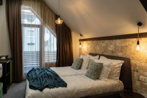 a bedroom with a bed with a brick wall at 103 Alpine Hotel in Panichishte