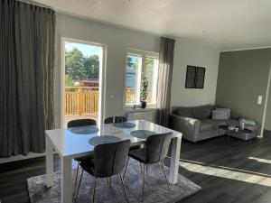 a living room with a white table and chairs at Torggatan 54 in Mariehamn