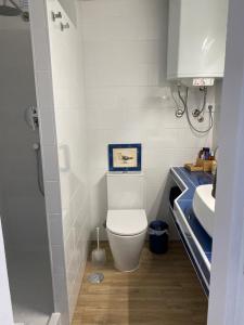 a small bathroom with a toilet and a sink at Pé no mar - Monte Gordo in Monte Gordo