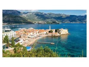 a view of a town on a body of water at Montelux Apartments in Budva