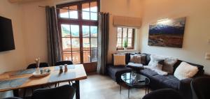 a living room with a couch and a table at Hochalmbahnen Chalets Rauris 1-11 WE2, Maislaufeldweg 1k OG in Rauris