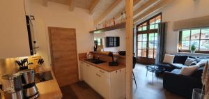 a kitchen and living room with a couch and a table at Hochalmbahnen Chalets Rauris 1-11 WE2, Maislaufeldweg 1k OG in Rauris