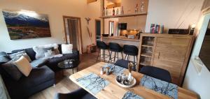 a living room with a couch and a table at Hochalmbahnen Chalets Rauris 1-11 WE2, Maislaufeldweg 1k OG in Rauris +3 photos