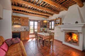 a living room with a table and a fireplace at Cortijo Prado Toro in Pitres