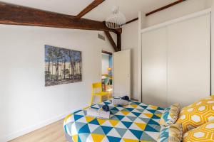 a bedroom with a bed and a painting on the wall at Aux portes de Bordeaux Le Loft Samba MindUrGuest in Bègles