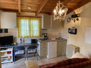 a kitchen with a table and a couch in a room at La Casita in El Jaral
