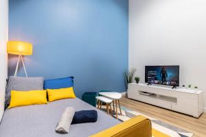 a living room with a bed and a flat screen tv at Aux portes de Bordeaux Le Loft Samba MindUrGuest in Bègles