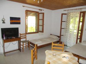 a room with a bed and a table and chairs at Villa Mina in Potistika