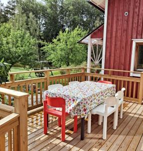 a table and chairs on a wooden deck at Solvillan in Korppoo