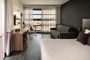 a bedroom with a bed and a living room at be.HOTEL in St. Julianʼs