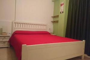 - une chambre avec un grand lit et une couverture rouge dans l'établissement Cozy apartment + parking Playa San Juan, à Guía de Isora