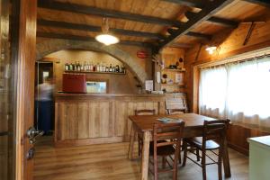 a kitchen and dining room with a table and a bar at Lou Subric in Stroppo +32 photos