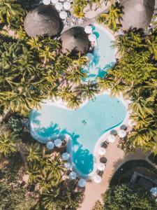 an aerial view of a swimming pool with palm trees at Canonnier Beachcomber Golf Resort & Spa in Pointe aux Cannoniers