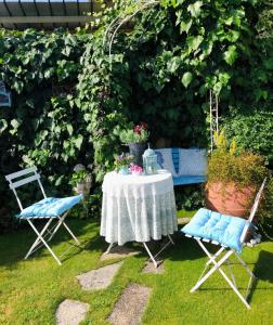 a table and two chairs in a garden with a table and chairs at B&B San Valerio in Occimiano