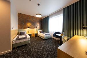 Postel nebo postele na pokoji v ubytování Hotel & SPA Hetman + 37 fotografií