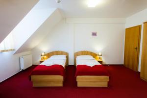 Posteľ alebo postele v izbe v ubytovaní Hotel pod Zámkom