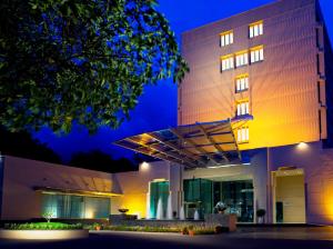 a building with a lit up facade at night at Blue Diamond Pune IHCL SeleQtions in Pune