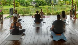 a group of people sitting in a yoga class at TheLifeCo Wellbeing Phuket Detox Center and Vegan Hotel - SHA Plus in Nai Thon Beach