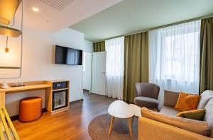 a living room with a couch and a table at The Weekend Hotel in Vienna