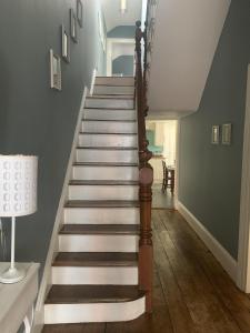 a staircase in a home with wooden floors at Beautiful Tenby House, pets allowed in Tenby