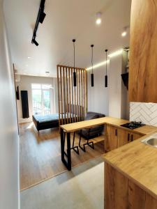 a kitchen with a table and a dining room at Wood Apartment in Odesa