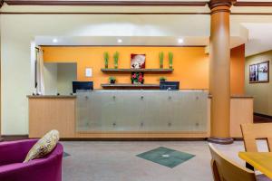 a lobby with a reception desk in a hospital at La Quinta by Wyndham Raleigh Crabtree in Raleigh