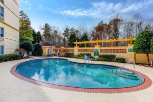 a swimming pool in the middle of a yard at La Quinta by Wyndham Raleigh Crabtree in Raleigh