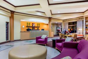 a lobby with purple chairs and a table at La Quinta by Wyndham Raleigh Crabtree in Raleigh