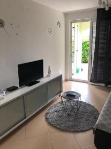 a living room with a tv and a table at Apartman Igor in Čižići
