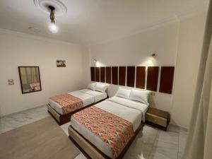 A bed or beds in a room at Kemet Apartment luxor